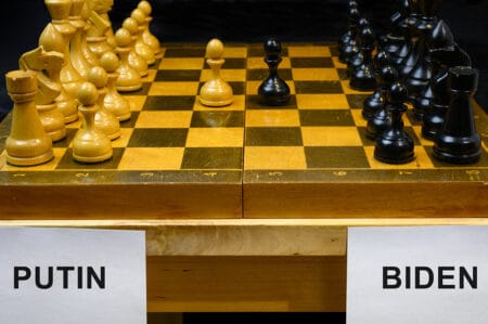 Putin and Biden by chessboard, chess like geopolitics game