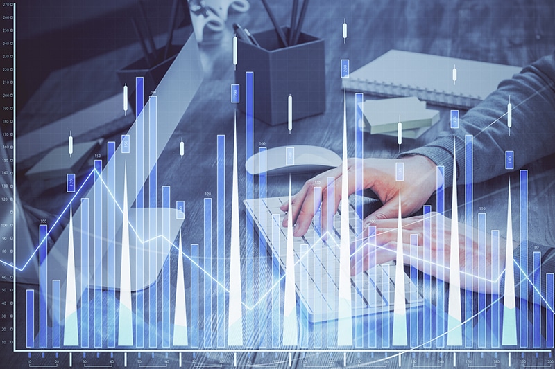 Double exposure of financial graph with man works in office on background.