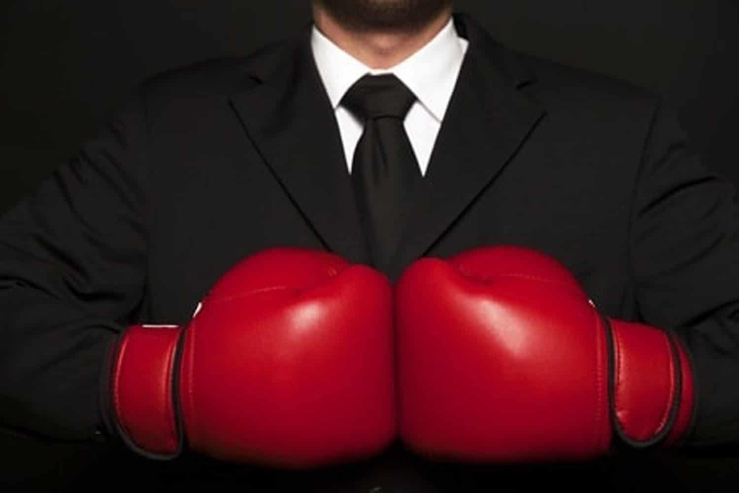 Man in suit and boxing gloves