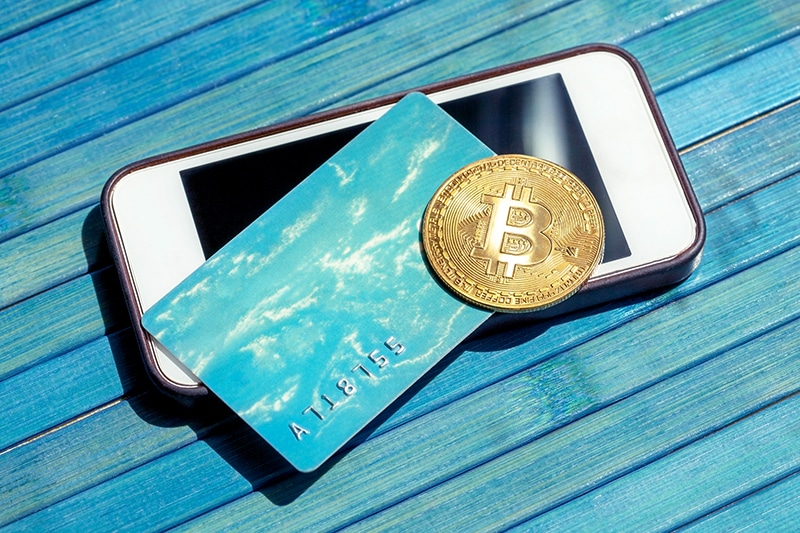 Bitcoin gold coin and a credit card