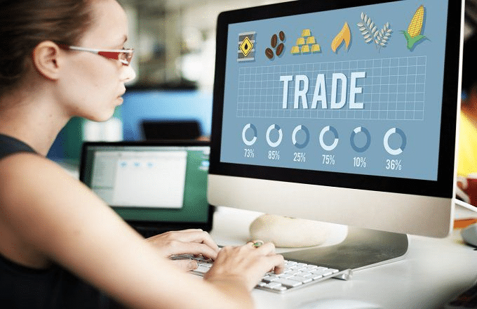 woman watching on the word "trade" on screen