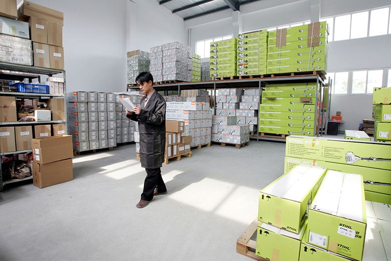 A Chinese worker checks the products in a warehouse at the plant of Taicang Andreas Stihl Powertools Co.