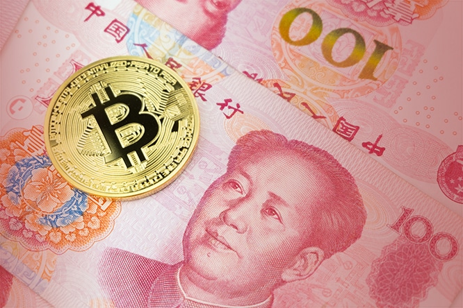 Golden bitcoin on pile of one hundred Chinese yuan banknotes background. Cryptocurrency, digital currency with yuan money bills.