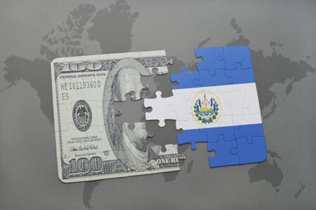 puzzle with the national flag of el salvador and dollar banknote on a world map background. 3D illustration