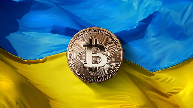 bitcoin Gold on a Ukrainian flag background.