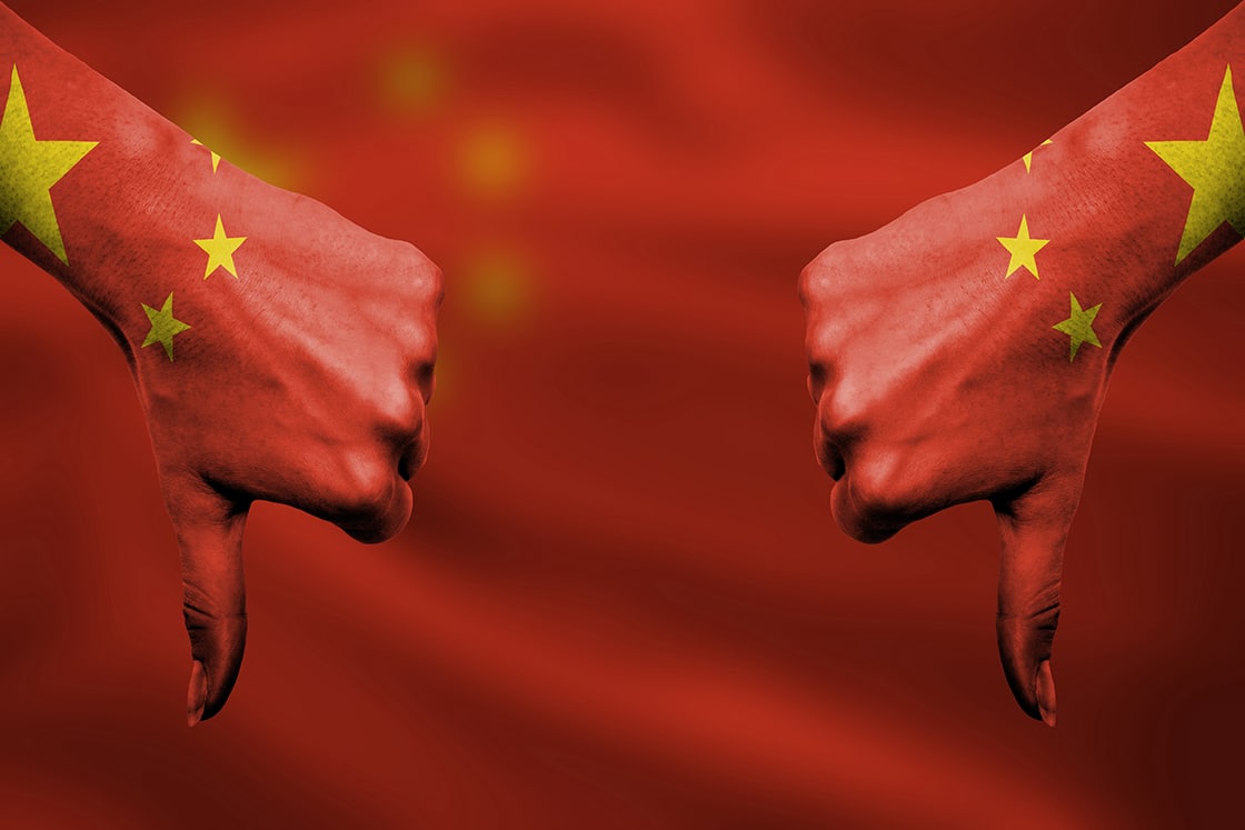 failure of China - hands gesturing thumbs down in front of flag