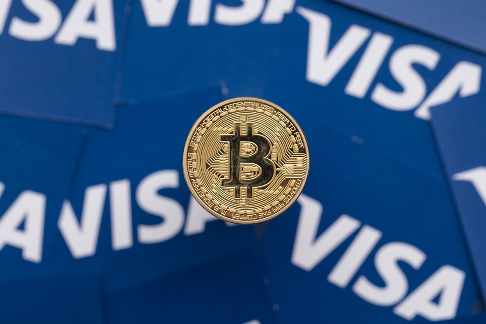 Bitcoin cryptocurrency on Visa financial service logo.