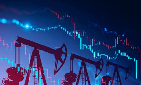 Three oil pumps over blue background with double exposure of falling blurry digital graphs. Concept of oil market crisis. 3d rendering toned image