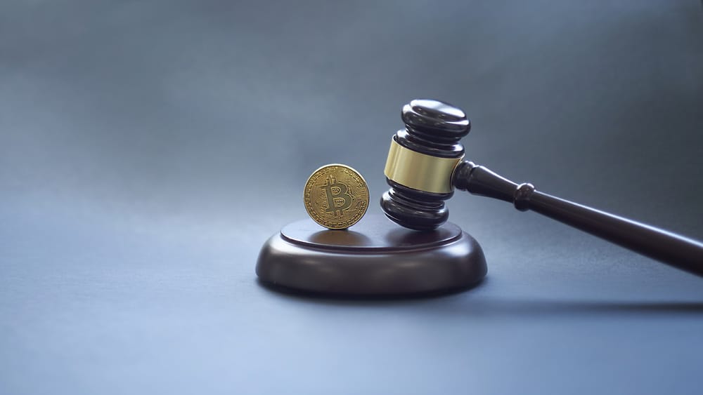 Crypto currency law theme, gavel and bitcoin symbol on black table with copyspace