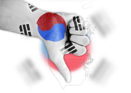 Thumbs down with digitally drawn South Korea flag