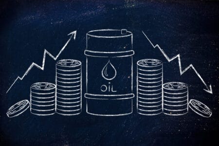 barrel of oil and coins, with up and down price rate arrows