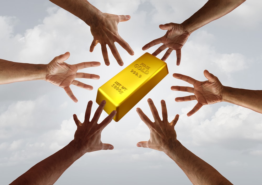 Gold demand and global commodity investment financial and business trade concept as diverse hands reaching for a golden bar with 3D illustration elements.