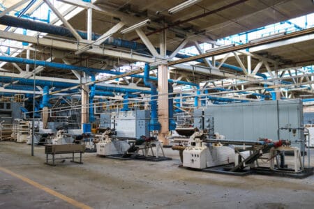 Beautiful metal industrial equipment of a production line at a machine-building plant, a conveyor with machine tools for products. Equipment refinery, petrochemical, chemical plant.
