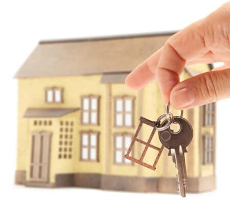 Handing keys in the house background isolated