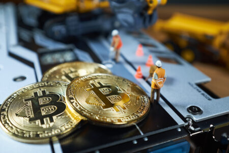 A little miner is digging on graphic card with golden coin. bitcoin mining and crypto currency concept.
