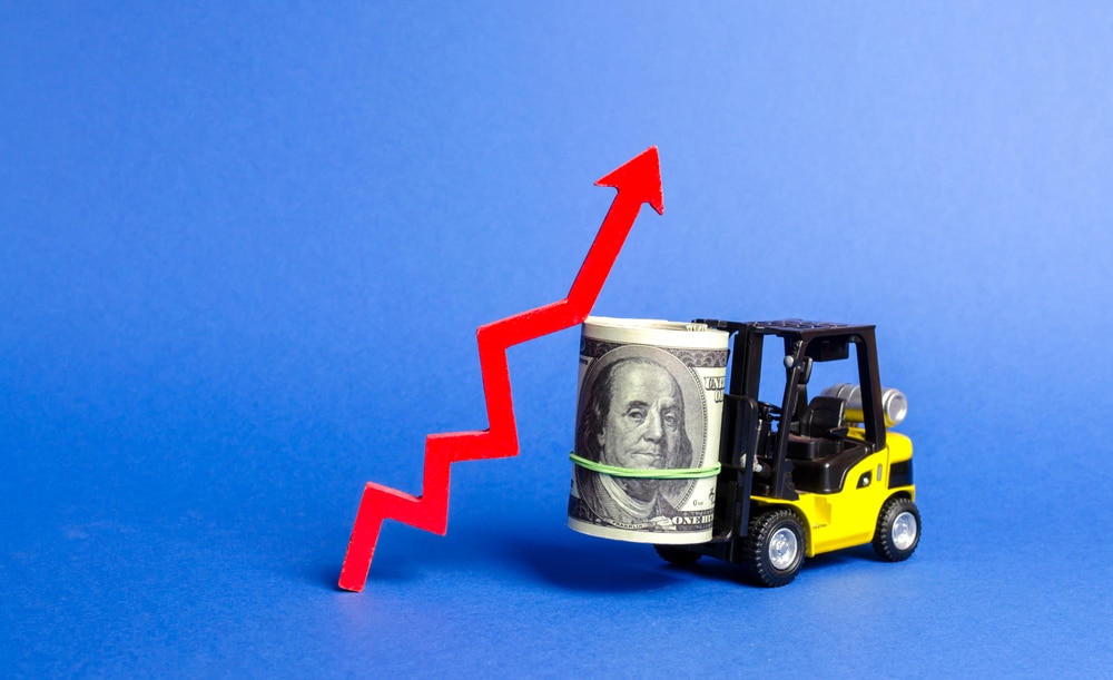 Yellow Forklift truck carries a big bundle of dollars and red up arrow. Growth of income and profit. progress of industrial and logistics industries, wage growth, Economic reforms, emerging markets