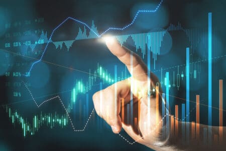 Businessman hand pointing at creative glowing forex graph on blurry bokeh background. Market analysis and trade concept. Double exposure