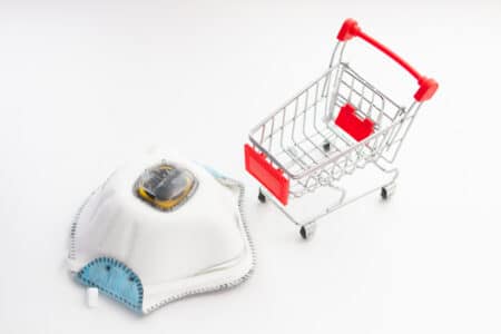 a respirator for PPE and toy basket for shopping. Epidemic deficit concept