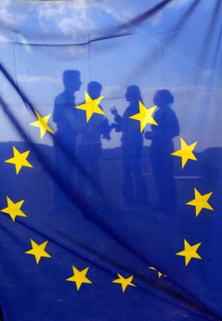 EU citizens with blue European Union flag with yellow stars