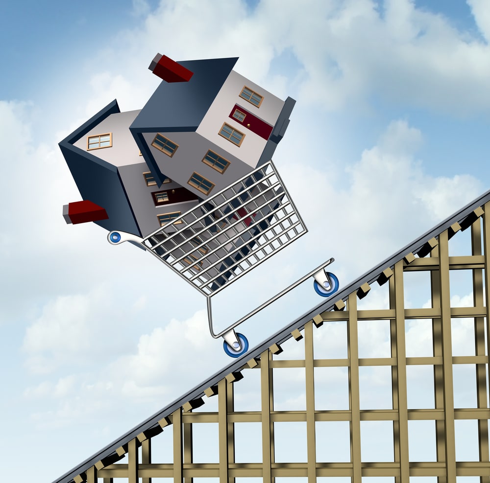 Rising house prices and home price price increase or growth as a soaring real estate value financial concept and sold houses in a shopping cart going up a roller coaster as surging residential business financial concept.